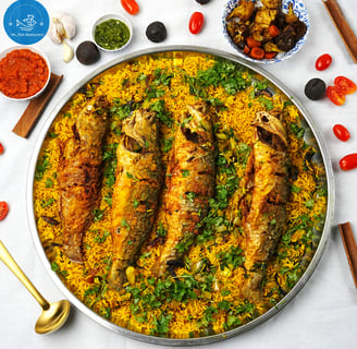 a pan of fish and rice with vegetables