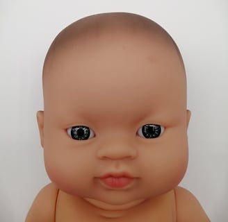 a Minikane baby doll with light coloured eyes