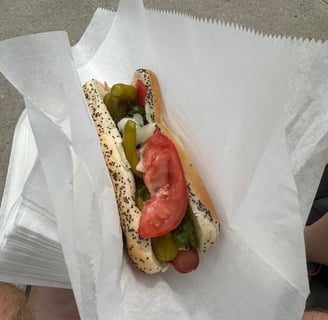 Chicago style hotdog with an all beef Frankfurt on a poppyseed bun with condiments