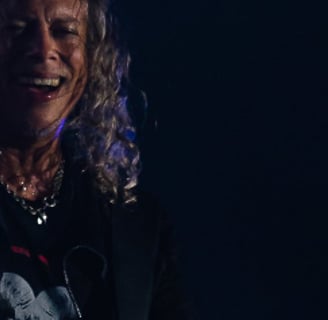 Kirk Hammett with a guitar and a microphone