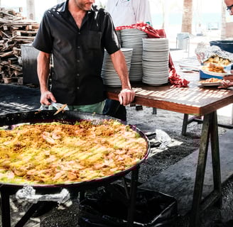 chefs plating a very big paella