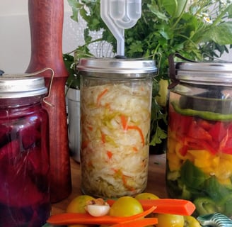 jars in colourful fermented food and wooden tamper