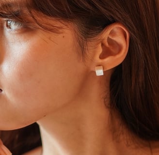 a woman with a pearl necklace and pearl earrings
