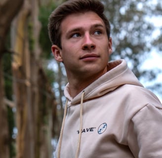 a man in a hoodie in a forest