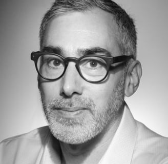 a man with glasses and a white shirt