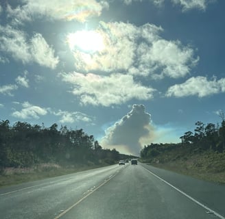 looking down the road at the smoke plume from Kilauea eruption