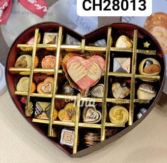 a heart shaped box with chocolates and candy