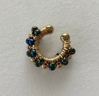 a gold and blue earring with a gold and green beaded earring