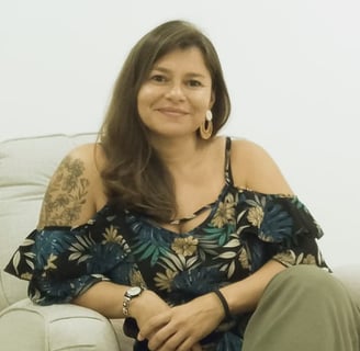 a woman therapist sitting on a couch in a therapy room