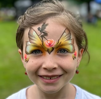 Young girl with face painting of butterfly wings, a fairy and roses. Fairy princess painting