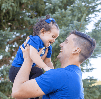 a man holding a baby in his arms