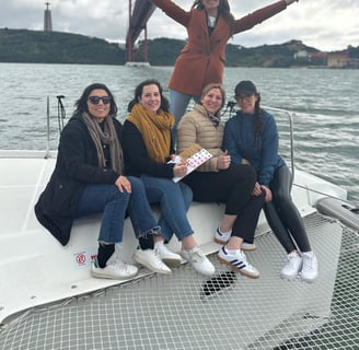 Bachelorette party aboard our Lagoon 46 with a view of the Cristo Rei and the 25th of April Bridge