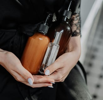 A woman holding three bottles of beauty creams like moisturizer, serums.