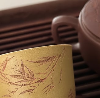 Yellow teacup engraved with artwork