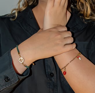 a woman with a black shirt and bracelets