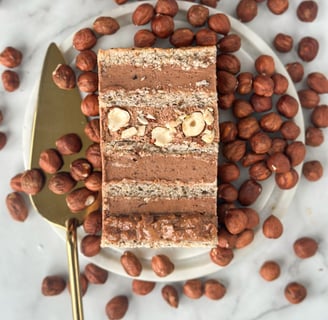 a piece of cake with nuts and nuts on a plate
