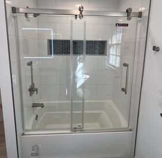 a new bathroom with a glass shower and a tub installed in South Jersey