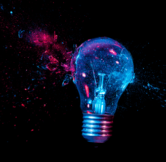 An artistic depiction of a shattered light bulb glowing in vibrant blue and pink hues, set against a