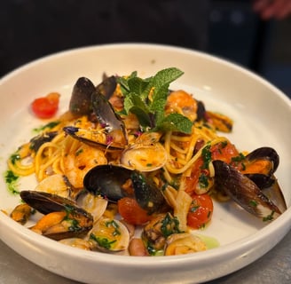 a plate of pasta with musselling and musselling
