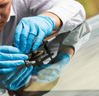 a man in gloves and gloves is holding a pair of scissors