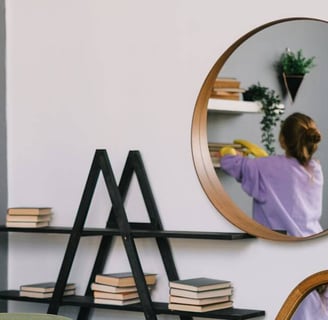 Dusting shelves during housekeeping service