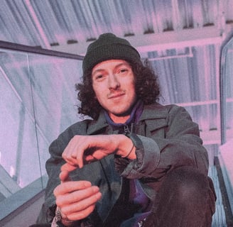 Photographic image of In VideColour's Sam Auckland, sitting in an industrial environment.