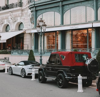 Luxury Cars Parked Outside Elegant Hotel Facade during Monaco Grand Prix