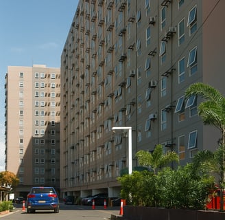a large building with many windows and cars parked in front of it