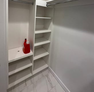 a white closet with shelves and shelves with a red fire hydrant
