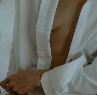 Minimalist close-up of a woman in an open white shirt — soft, sensual morning moment