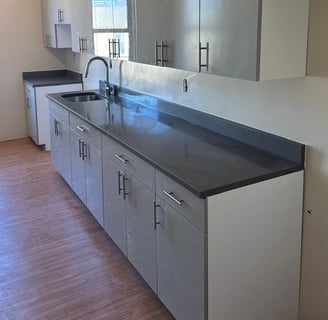a kitchen with a counter top and cabinets