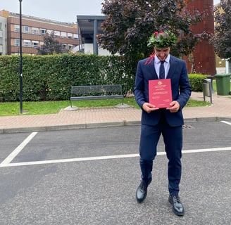 a man in a suit and tie is holding a certificate