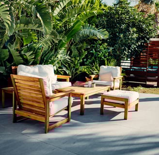 a patio with a wooden patio furniture set