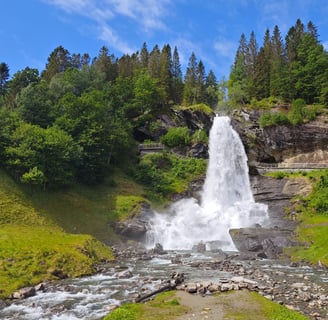 Steindalsfossen waterfall surrounded by greenery in Norway