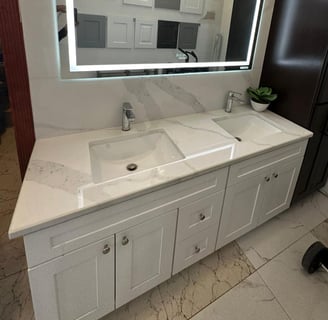 a bathroom with a large mirror and a chandelier