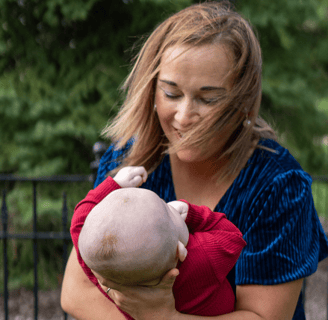 a woman holding a baby in her arms