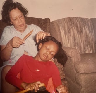 Granny braiding my hair while I braid a doll's hair