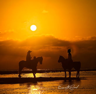 Two people riding horses on Gili Trawangan beach