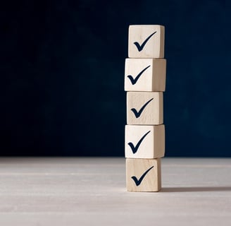 Stack of wooden blocks with black check/tick marks on them