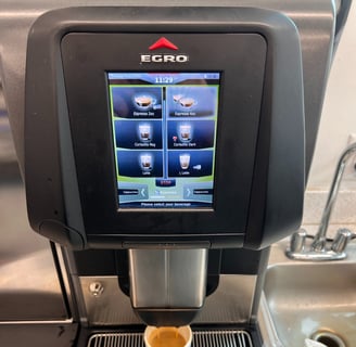 Egro super-automatic espresso machine preparing a cup of coffee.