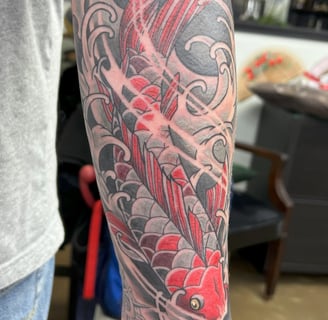 a tattoo on the arm of a man's arm koi fish color tattoo