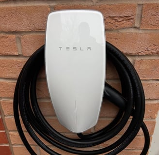 Installation we carried out of tesla wall charger EV with a charging cable attached