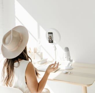 a woman in a white dress and hat sitting at a desk, lifestreanimg