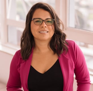 a woman therapist in her office in front of a window