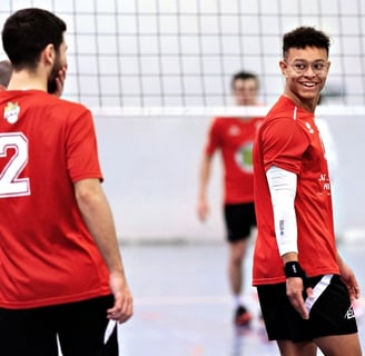a group of men playing volleyball