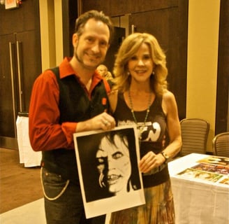 a man and woman holding a picture of a photo