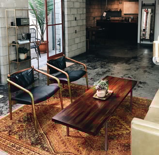 a living room with a couch and chairs