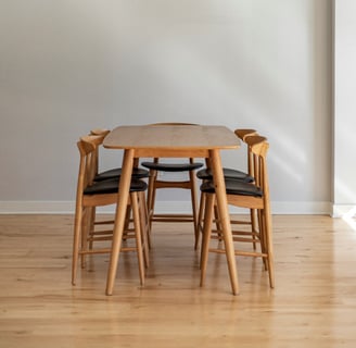 a dining room table with chairs and a chandelier