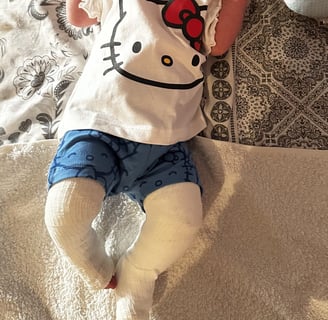 a baby is laying on a blanket on a bed