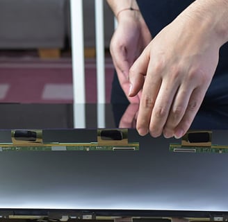 a person holding a laptop computer screen with a laptop on it